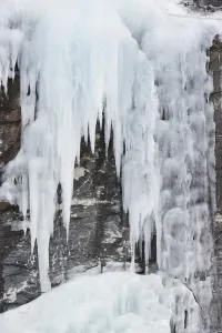 Icicles in front of a rock face