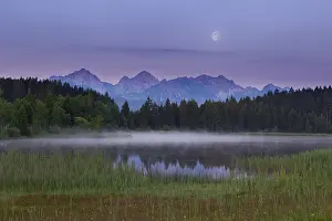 Category Mountain Landscapes Prints: Idyllic lake at dusk with mountains and forests in the background