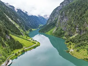 An idyllic mountain lake, surrounded by mountains and lush greenery