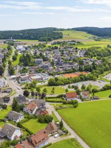 Idyllic village with green fields and hilly landscape