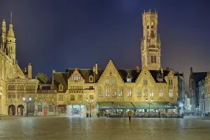 Illuminated castle square and belfry at night