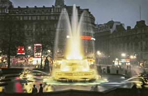 Illuminated fountain and neon lights in Trafalgar Square in the centre of London, England, United Kingdom October 1960