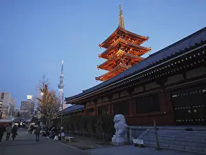 Illuminated pagoda in a temple complex at sunset