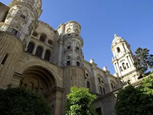 Imposing cathedral with two towers and richly decorated facades against a blue sky