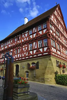 Impressive half-timbered building with eye-catching wood design against a blue sky