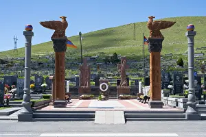 Impressive monument with eagle statues in a peaceful cemetery setting