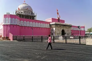 An impressive pink temple with striking architecture and historical flair under a blue sky
