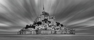 Impressive view of Mont Saint-Michel in black and white, surrounded by dramatic clouds, Le Mont-Saint-Michel