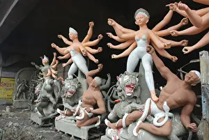 Category Historic EN Prints: Incomplete Durga idols with demon making at Kumartuli