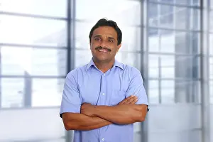 Indian latin businessman blue shirt in modern office background