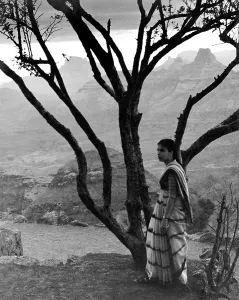 Indian woman in saree standing near tree at Matheran, Maharas htra, India 1940's