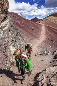 Indigenous guide with packhorse in the rainbow mountains