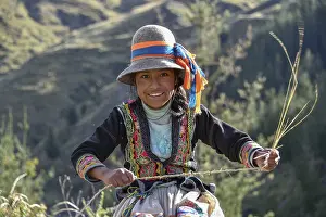 Framed Print : Indio girl with hat smiles and weaves Pacha grass