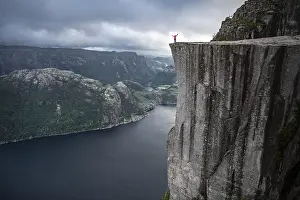 Individual on rock plateau, Preikestolen rock spire