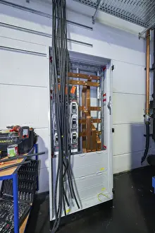 Category Historic EN Prints: Industrial cable cabinet with exposed cables and technical components