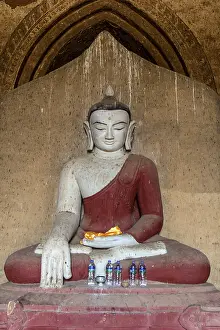 The interior of Buddhist Temple with statue of sitting Buddha