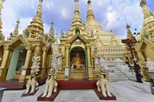 Interior of a temple with several Buddha statues and a reclining Buddha against a glittering background