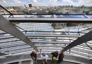 Interior view of the Reichstag dome with visitors on the ramp and view of the cityscape