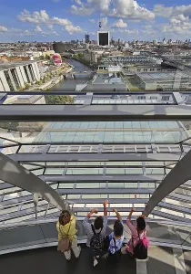 Interior view of the Reichstag dome with visitors on the ramp and view of the cityscape