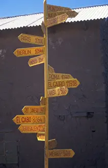 International guide on Isla Taquile in Lake Titicaca shows the distances to cities around the world
