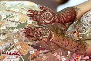 Intricate henna designs adorn the hands of a bride