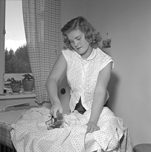 Ironing in the 1950s. A woman seen ironing her clothes. She is actress Sonja Stjernquist 1931-2002. Sweden 1951. Conard ref 1743