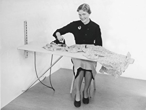 Ironing in the 1950s. A woman seen ironing her clothes. Sweden 1955