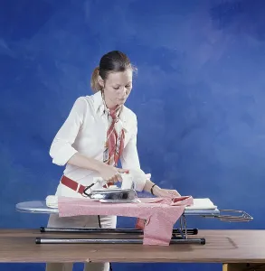 Ironing in the 1970s. A woman seen ironing her clothes