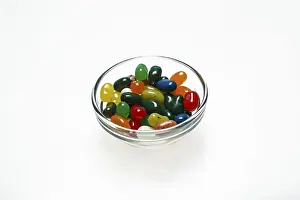 Jelly beans in bowls on white background