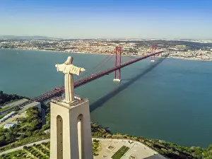 Jesus Christ monument by Tagus river with bridge Ponte 25 de Abril
