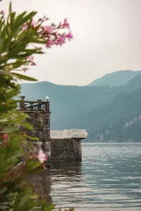 A jetty with a stone terrace juts out into Lake Como