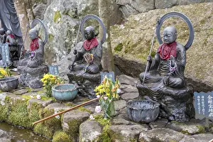 Jizo statues with prayer beads and red scarves in Japan