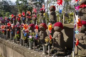 Jizo statues with red crocheted caps
