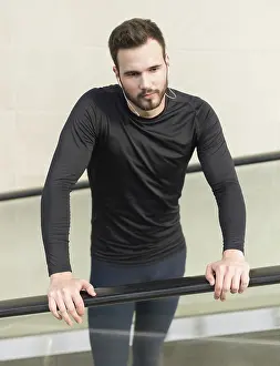 Jogger resting after running. Man runner taking a break during training outdoors in city