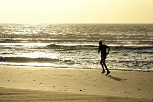 Jogging on the beach at sunrise