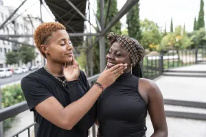 A joyful LGBT multiethnic couple shares a tender moment outdoors