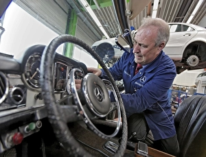 Juergen Kaltschmitt working on his vintage Mercedes Benz convertible SL 250 Pagoda