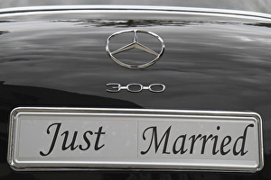 Just Married licence plate on the back of a vintage black Mercedes Benz 300 car<br>'Just Married licence plate