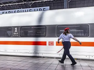 Karlsruhe main station with ICE and employee of Deutsche Bahn AG