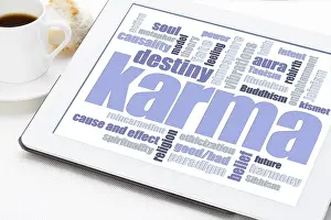Karma word cloud on a digital tablet with a cup of coffee - spiritual concept