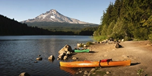 Kayaks beached on the shore of an Oregon Lake