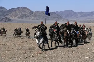 Kazakhs eagle hunters on their way the to the Golden Eagle Festival