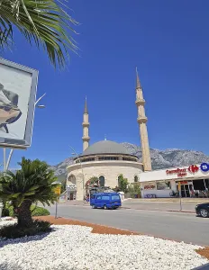 KEMER, TURKEY - JULY 5, 2025 Kemer city centrum view with grand mosque Huzur Camii Dzamija with two minarets and dome