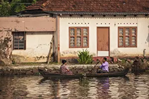 KERALA, INDIA, MAY 5, 2010: Unidentified indian people in small boat in backwaters