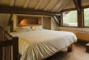 Category Buddhism Prints: King size bed with wood frame in sparsely furnished Zen style master bedroom on mezzanine inside Scandinavian hybrid