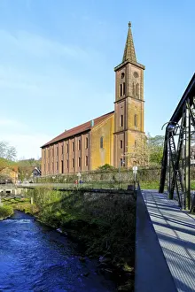 Kinzig and town church with steel girder bridge in Schiltach