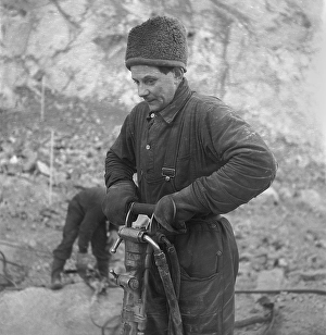 Kiruna Sweden in the 1950s. The open mine and workers drilling holes to put explosives