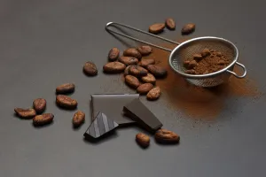 Kitchen sieve with cocoa powder and chocolate