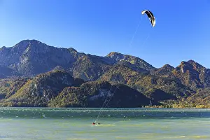 Kite surfer on a lake in front of mountains