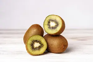 Kiwi slices on a white wooden table